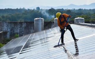 Photovoltaik-Techniker reinigten und wuschen die Oberfläche der Solarmodule, die Staub und Vogelkot aufwies foto