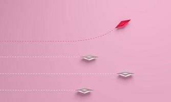 Disruptionskonzept für Frauen. individueller und einzigartiger führer rosa papierschiff mit wechselnder richtung. foto
