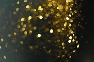 goldene glitzernde bokeh-beleuchtungsbeschaffenheit verschwommener abstrakter hintergrund für geburtstag, jahrestag, hochzeit, silvester oder weihnachten foto