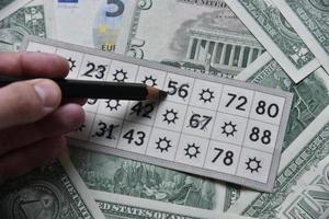 Dollarscheine und Lottoscheine mit einem Bleistift foto