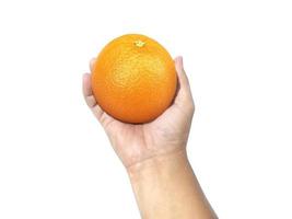 menschliche Hand, die eine Orange auf einem weißen Hintergrund isoliert hält foto
