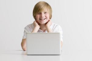 lächelnder Student, der am Laptop arbeitet