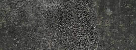 schwarzer wandhintergrund.betonwand verputzter dunkler kratzerhintergrund.grunge textur. foto