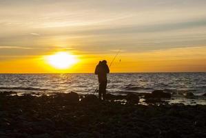 Angler im Sonnenuntergang foto