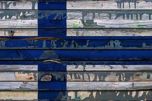 die nationalflagge von finnland ist auf unebenen tafeln gemalt. Ländersymbol. foto