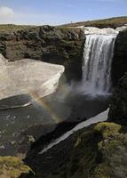 Wunderschöne Kombination aus Regenbogen, Gletscher und Wasserfall in Island foto