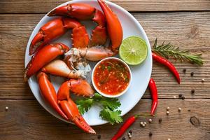 Frische Krabben auf weißem Teller, Krabbenkrabben, die Meeresfrüchte mit Zitronenlimette kochen, gekochtes oder gedämpftes Krabbenrot im Restaurant - Draufsicht foto