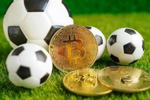 Gold-Bitcoin mit Fußball oder Fußball, Kryptowährung, die bei Online-Sportwetten verwendet wird. foto