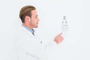 Optiker im Mantel, der Sehtest zeigt