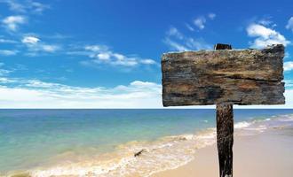 Holzschild am Strand und Meer foto