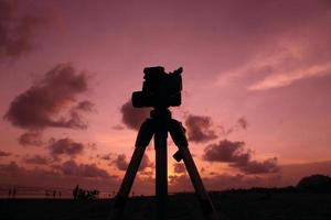 Silhouette der Kamera mit Stativ im Sonnenuntergang foto