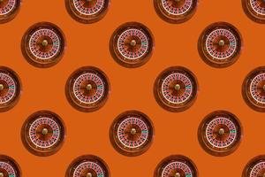 Nahtloses Muster von Spieltisch-Roulette aus dem Elite-Casino auf orangefarbenem Hintergrund foto