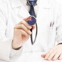 Arzt hält Stethoskop mit Flaggenserie - Neuseeland foto
