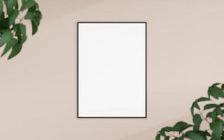 Saubere und minimalistische Vorderansicht vertikales schwarzes Foto- oder Posterrahmenmodell, das mit verschwommenen Pflanzen an der Wand hängt. 3D-Rendering. foto