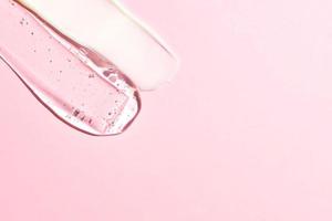 Verschiedene Kosmetikmasken, Cremes, Serum, Peeling und Lotionsabstrich auf rosafarbenem Hintergrund. Schönheit Textur. Probe eines kosmetischen Produkts. Platz für Text kopieren foto