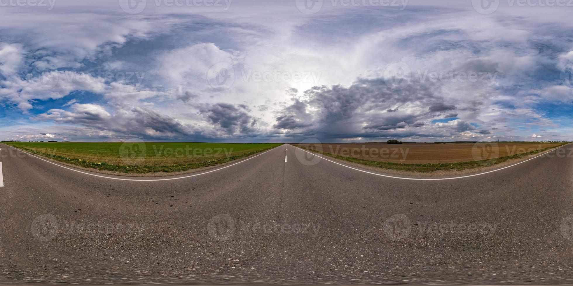 full sfärisk sömlös hdri panorama 360 graders vinkelvy på ingen trafik asfaltväg bland fält på kvällen före solnedgången med molnig himmel. 360 panorama i ekvirektangulär projektion, vr ar innehåll foto