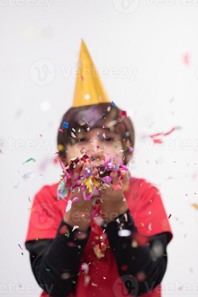 barn som blåser konfetti foto