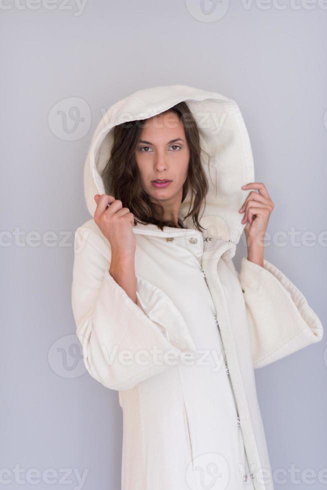 kvinna i en vit rock med huva isolerad på vit bakgrund foto