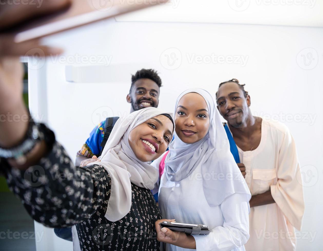 videograf i rosa studio spelar in video på professionell kamera genom att skjuta kvinnlig muslimsk kvinna foto