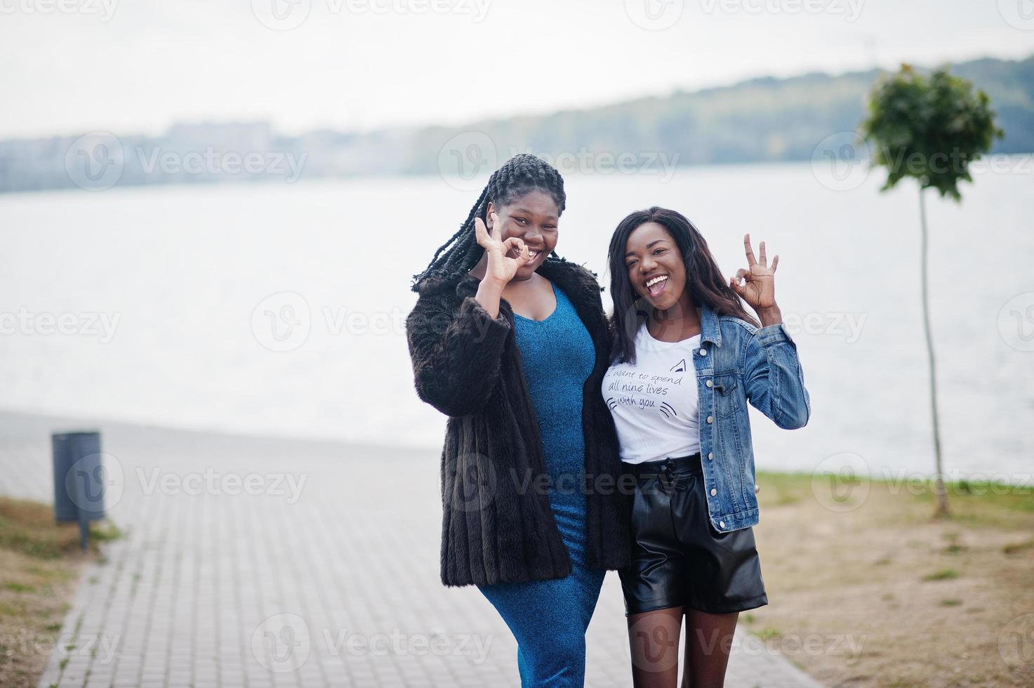 två afroamerikanska mörkhyade vänner kvinnliga. en av dem plus size-modell, andra smal. ha kul och umgås tillsammans. foto