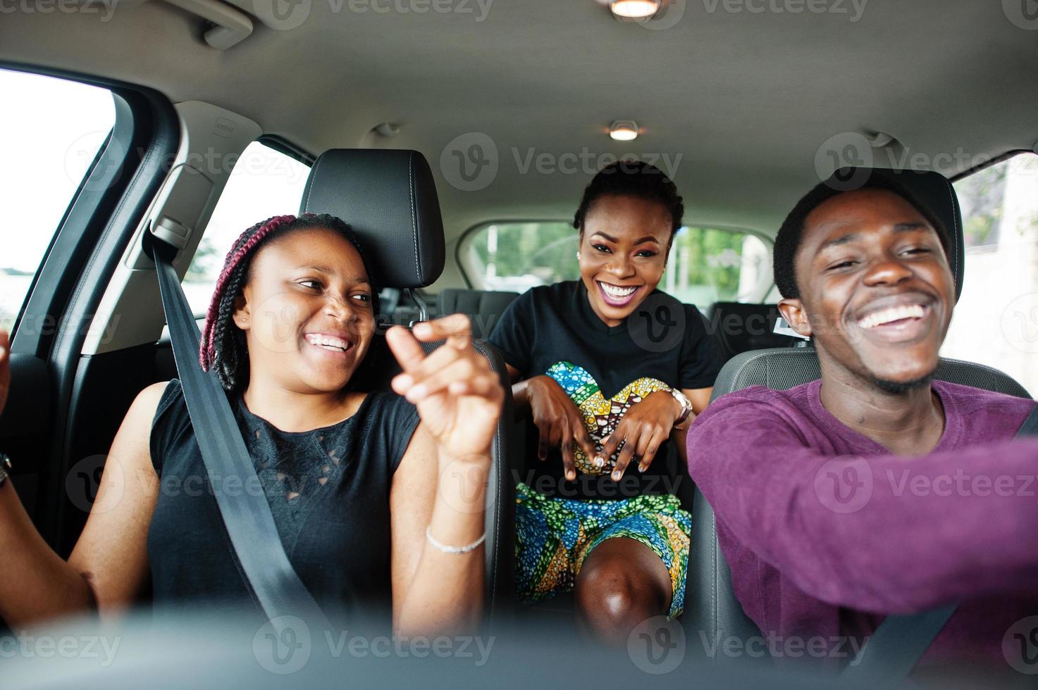 unga afroamerikanska vänner sitter i en bil. foto