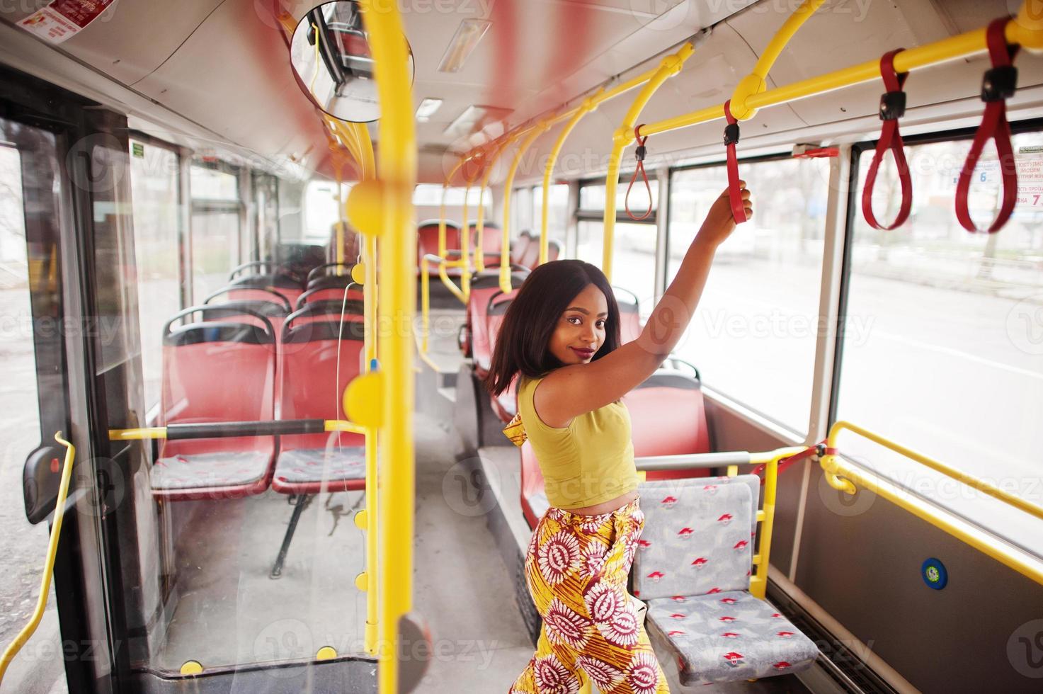 ung elegant afrikansk amerikansk kvinna som rider på en buss. foto