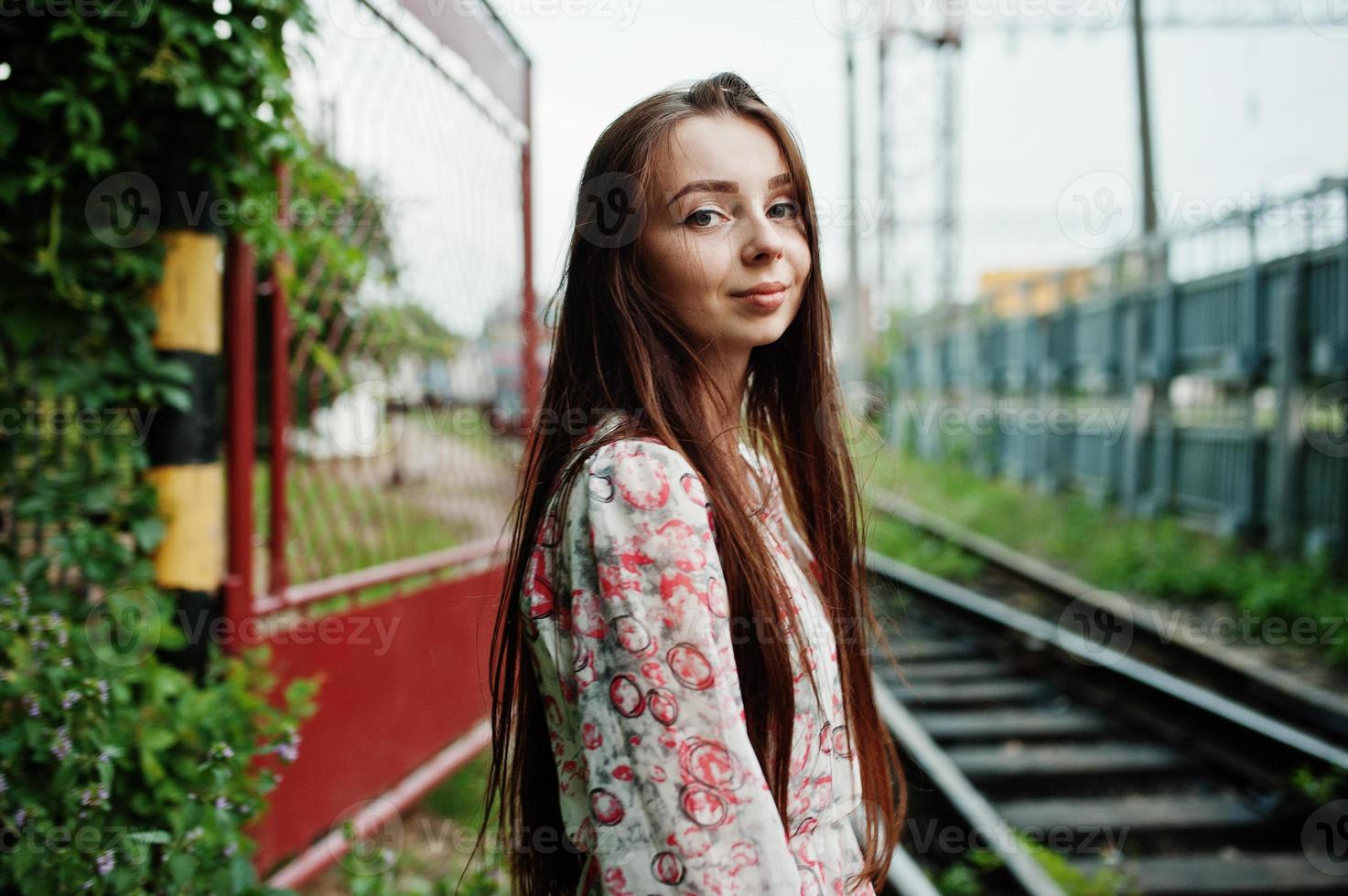 livsstil porträtt av ung flicka poserar på tågstationen. foto