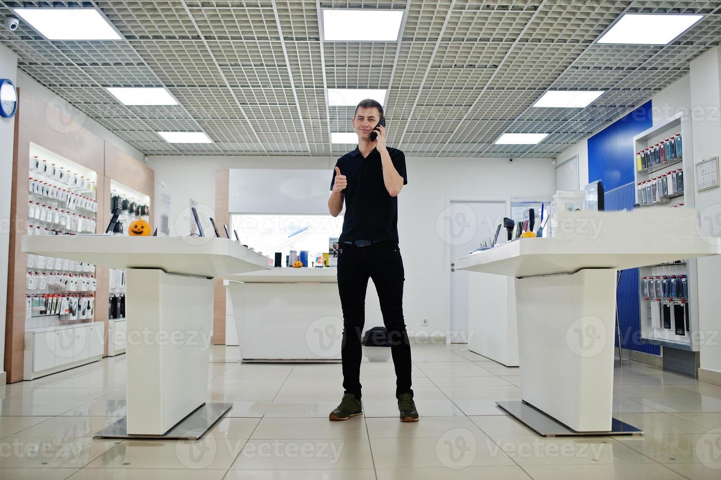 säljare man mobiltelefon professionell konsult i teknisk butik eller butik. foto