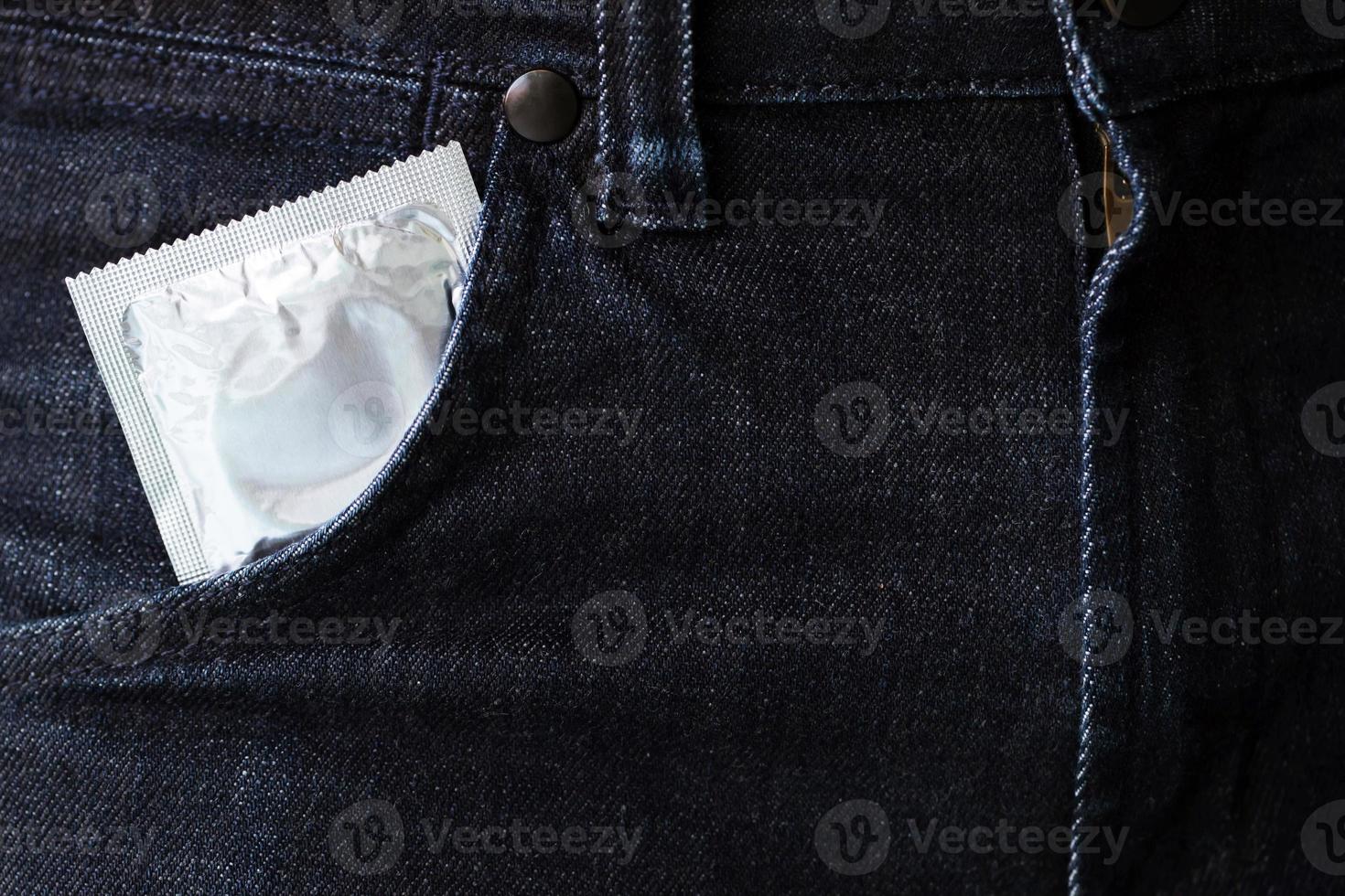 kondom redo att användas i fickan jeans byxor, ge säkert sex koncept på sängen förhindra infektion och preventivmedel kontrollera födelsetal eller säker profylaktisk. Världsaidsdagen, foto