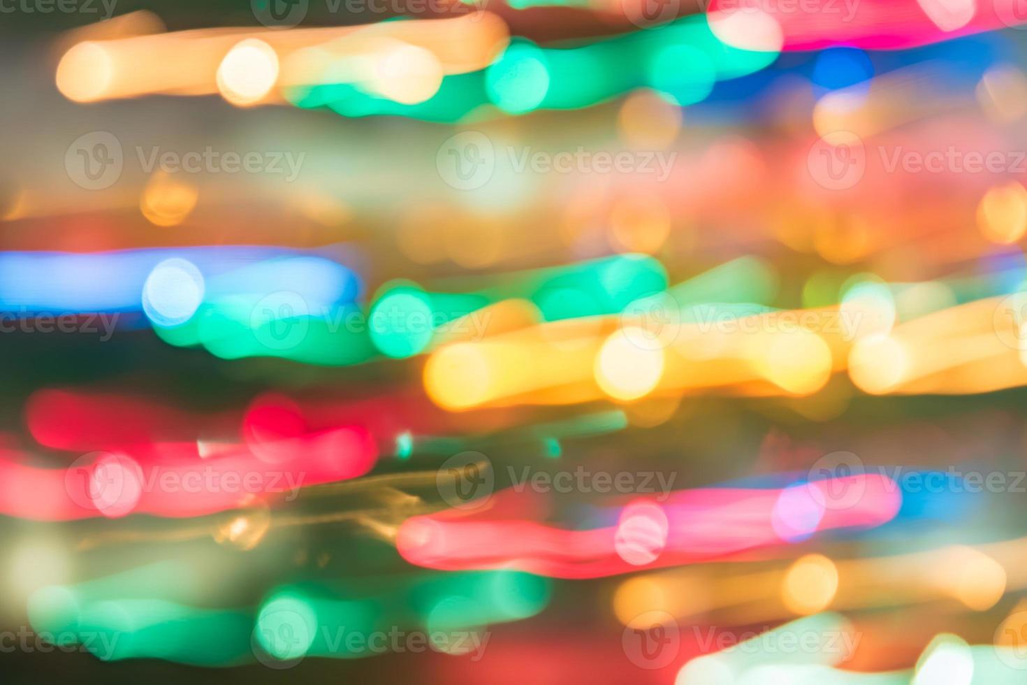 abstrakt burred textur bakgrund av färgglada bokeh rörelse. lång exponering av små neonljus foto