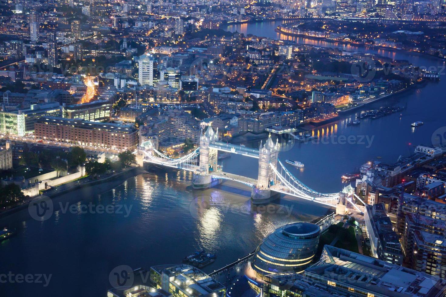 London på natten med stadsarkitekturer och tornbro foto