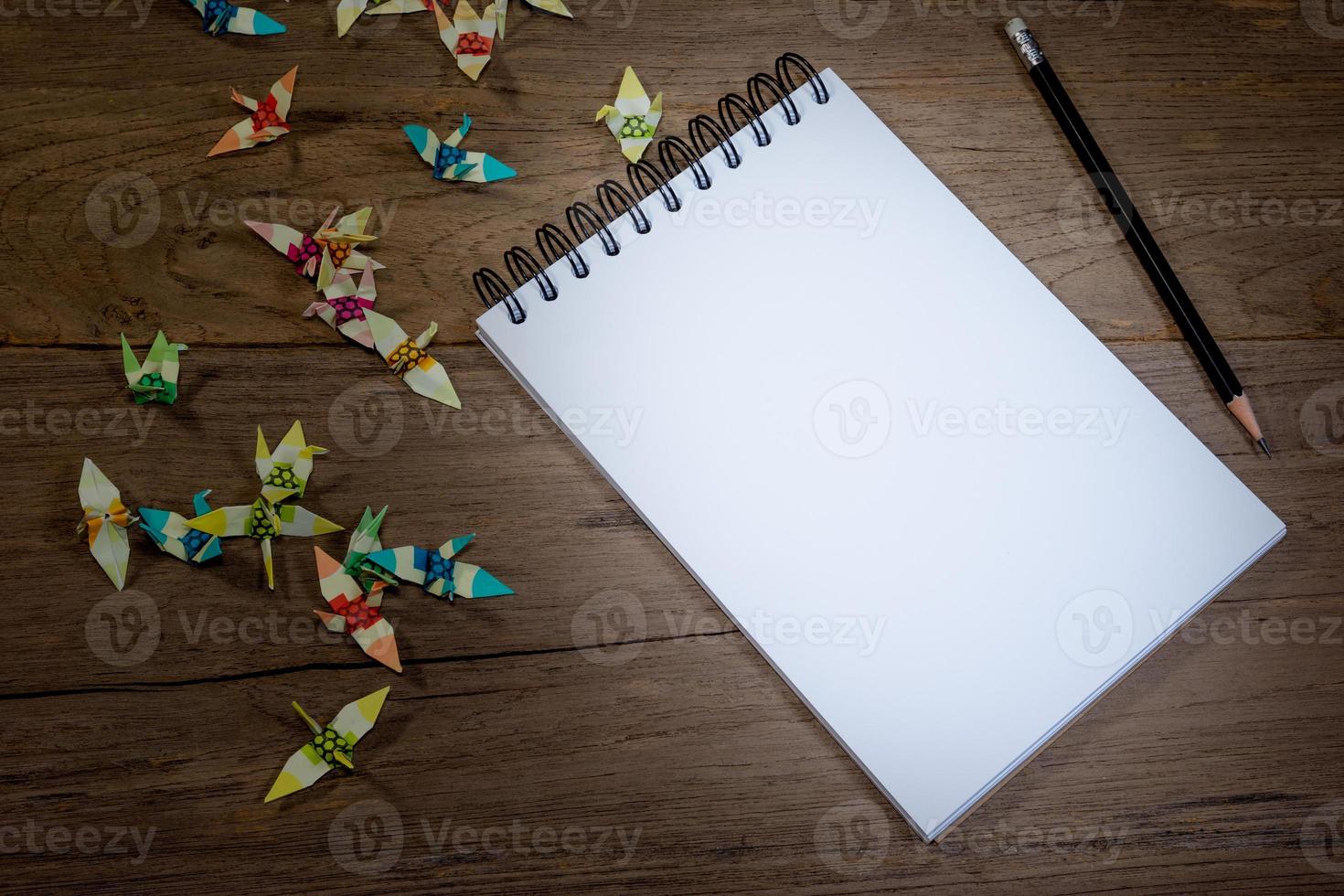 öppen notera bok med penna på trä bakgrund foto