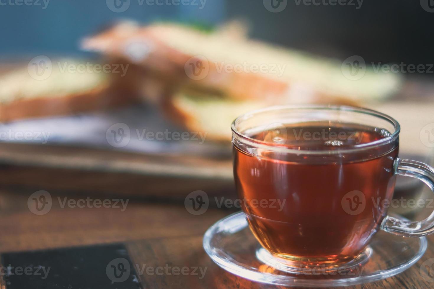 kopp av te på en Kafé suddig bakgrund och vitlök bröd. foto