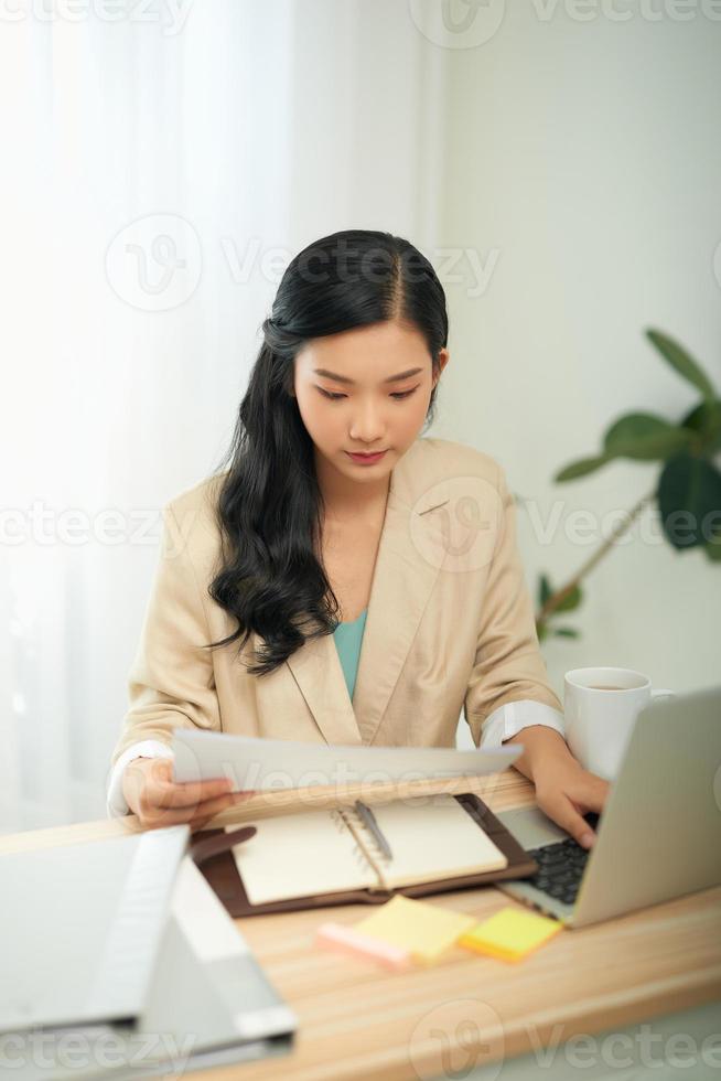 attraktiv affärskvinna studerar uppkopplad, använder sig av bärbar dator programvara, webb surfing information eller handla i internet Lagra. foto