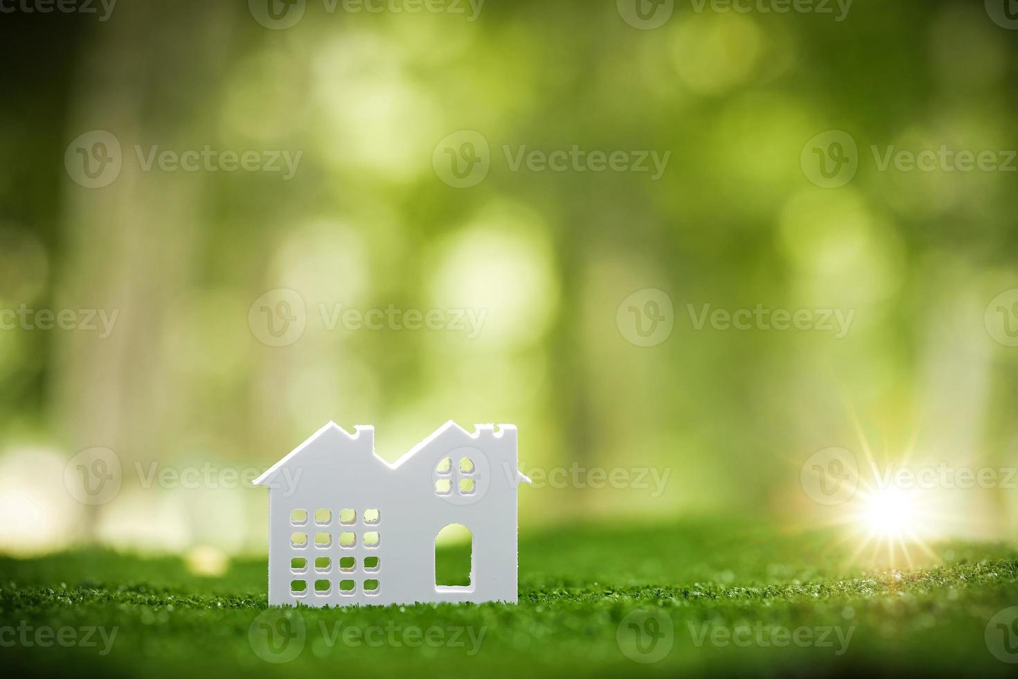 miljömässigt miljövänlig verklig egendom hus. små modell byggnad fast egendom Hem på gräs i grön natur ekologi. hållbar energi bevarande bostads- design och sälja - hyra företag begrepp foto
