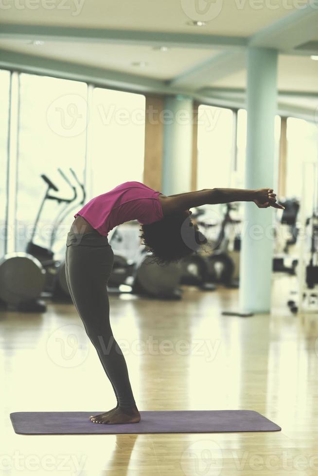 afrikansk amerikan kvinna övning yoga i Gym foto