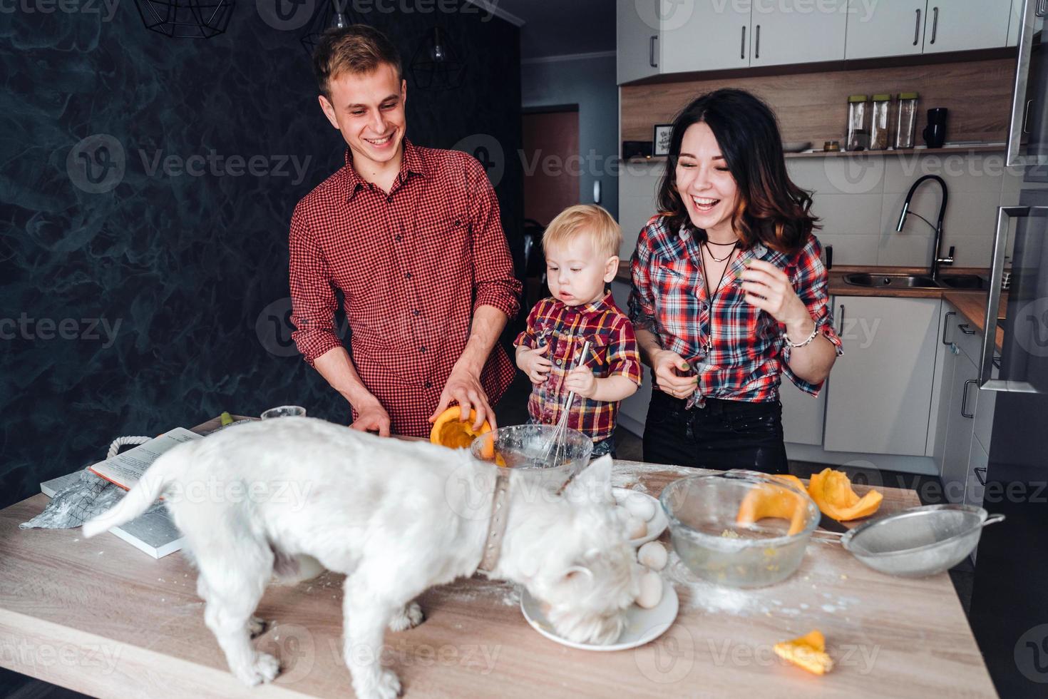hund på de kök tabell. Lycklig familj i de kök foto