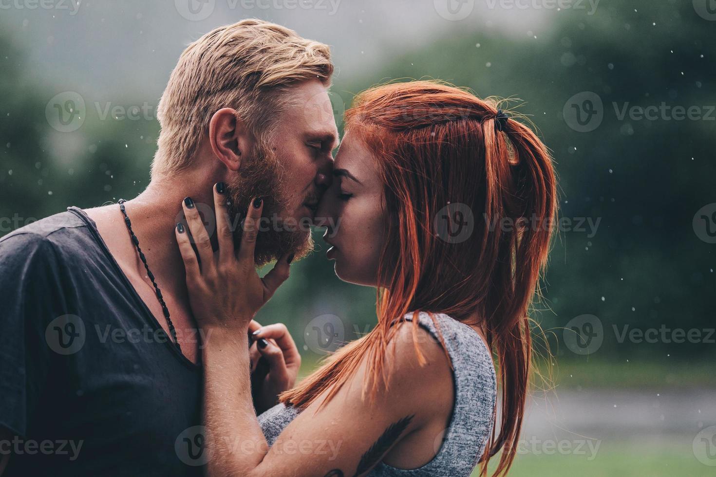 skön par kissing i de regn foto