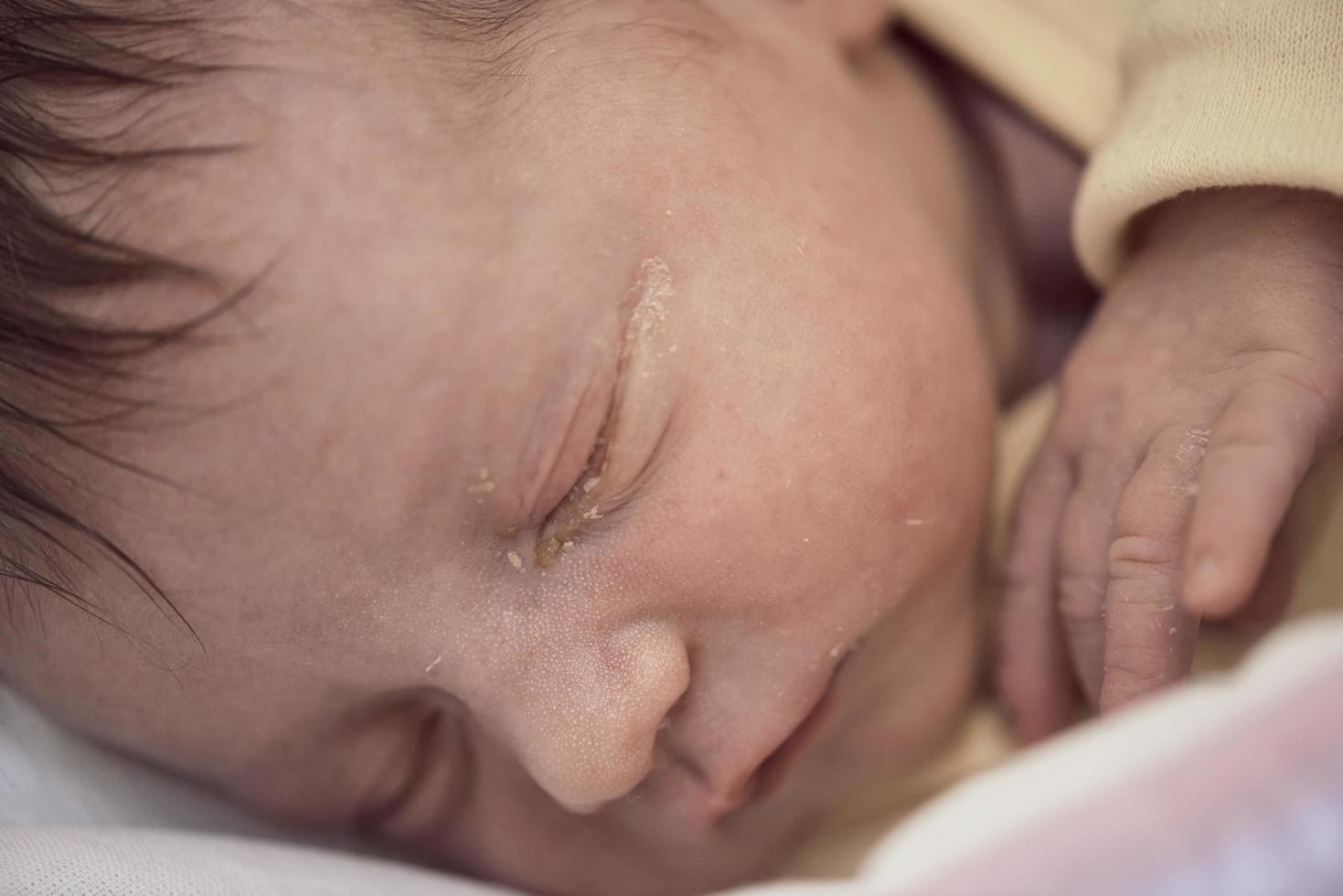 nyfödd bebis sovande i säng på sjukhus foto