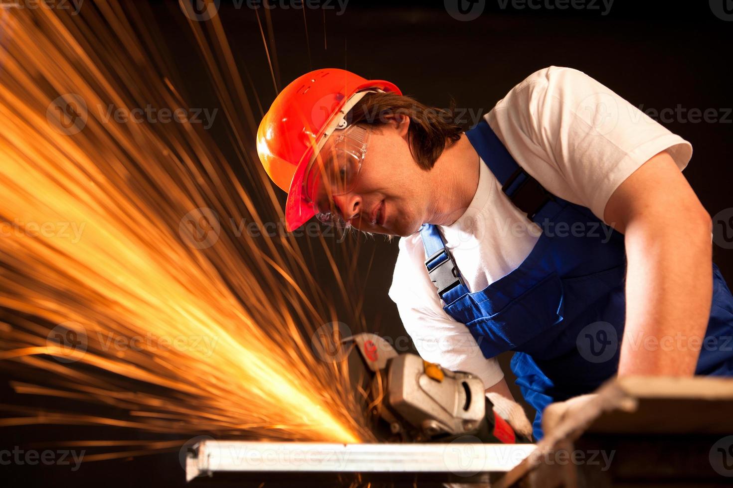 arbetare skär metall foto