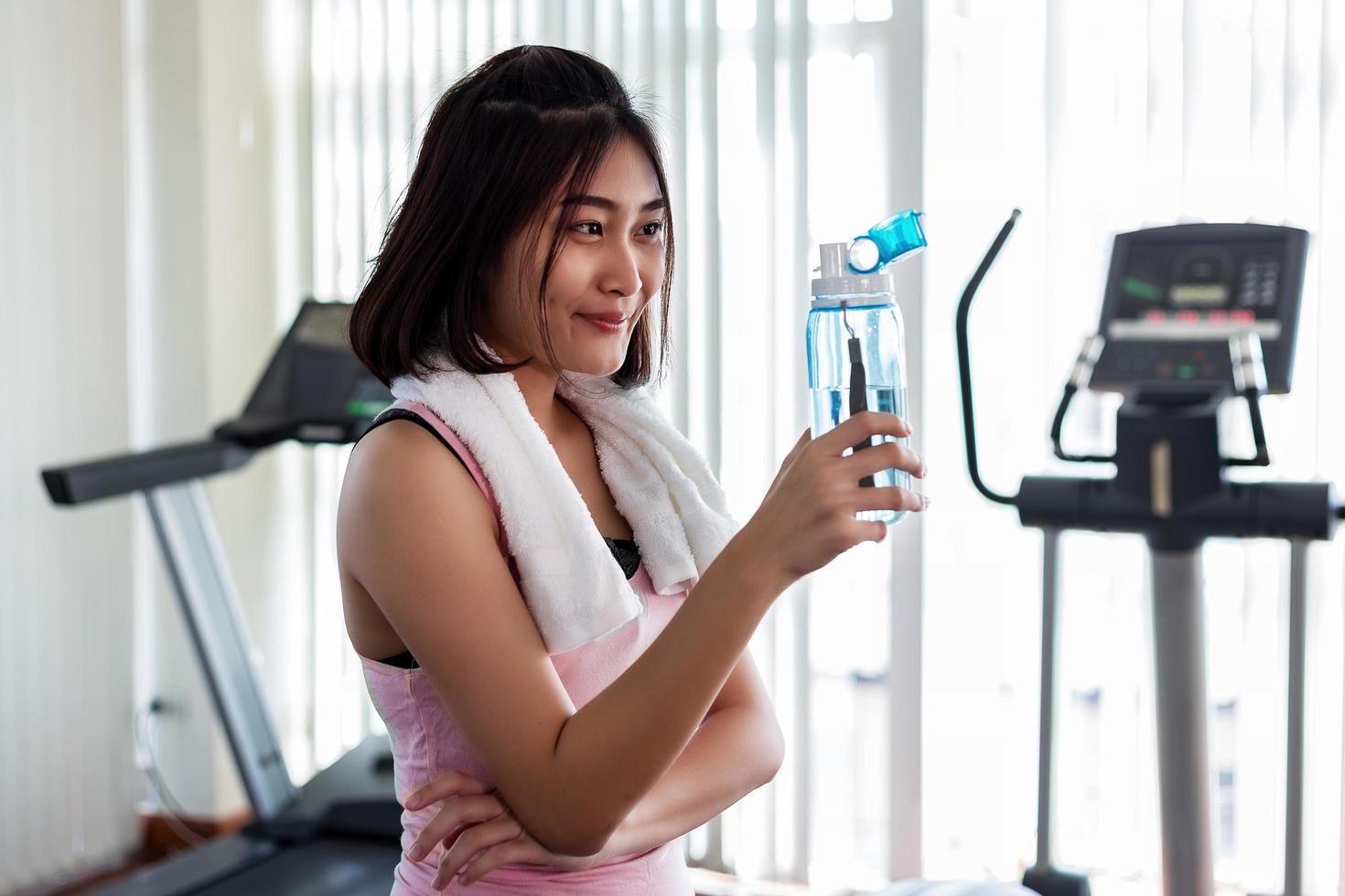 kvinna med vattenflaska på gymmet foto