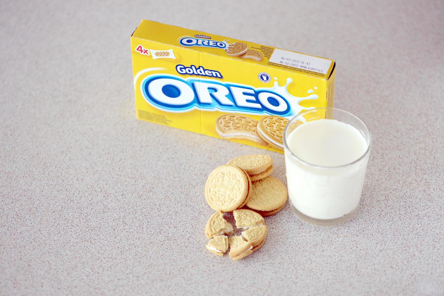 ternopil, ukraina - Maj 28, 2022 oreo gyllene Krispig småkakor med glas av mjölk på vit bakgrund. de varumärke oreo är ägd förbi företag mondelez internationell foto