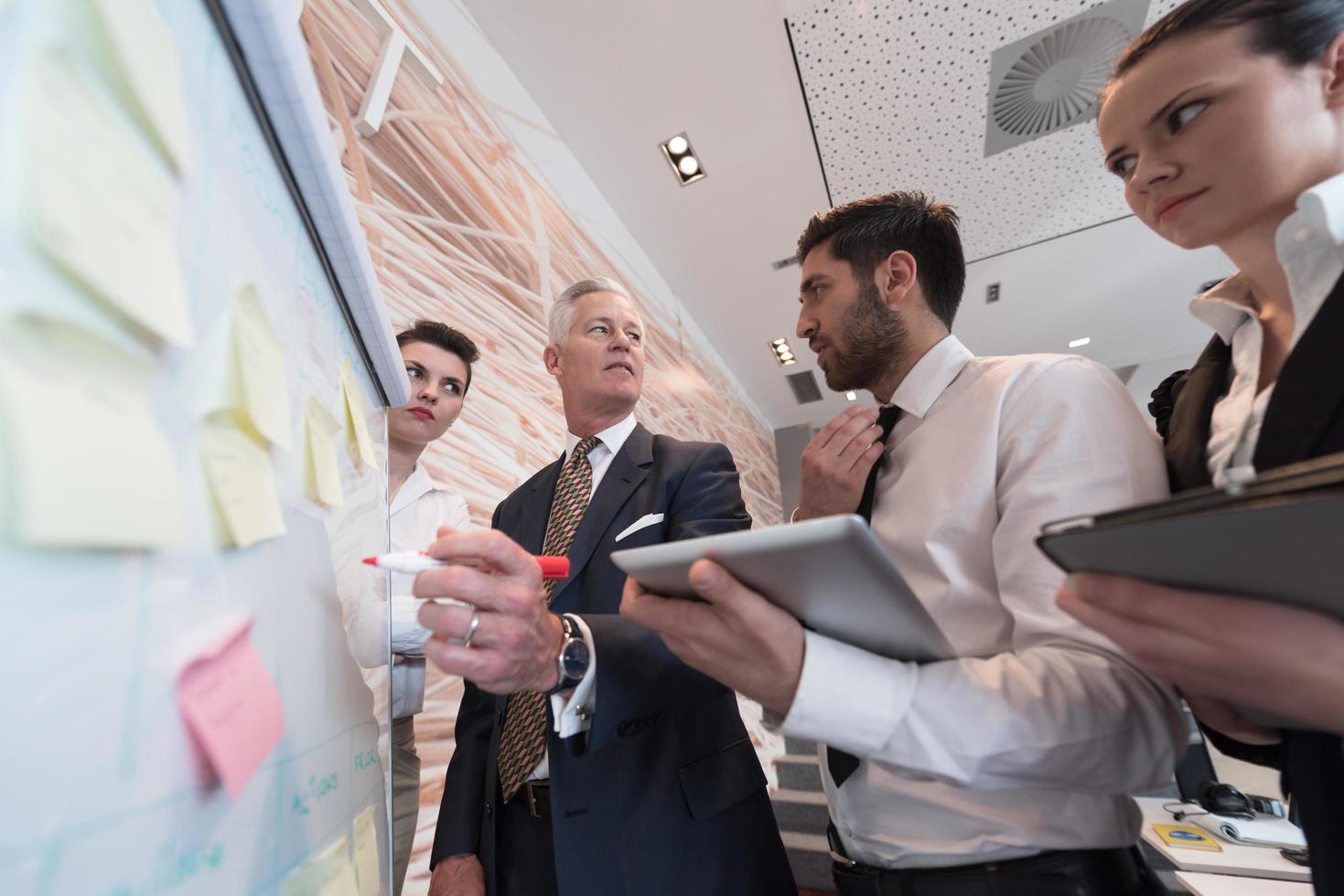 företag människor grupp brainstorming och tar anteckningar till flipboard foto