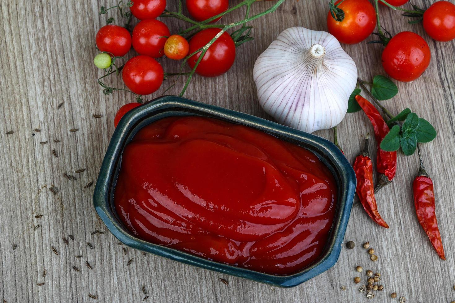 tomat ketchup i en skål på trä- bakgrund foto