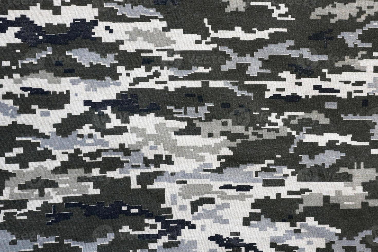 tyg med textur av ukrainska militär pixeled kamouflage. trasa med camo mönster i grå, brun och grön pixel former. officiell enhetlig av ukrainska soldater foto