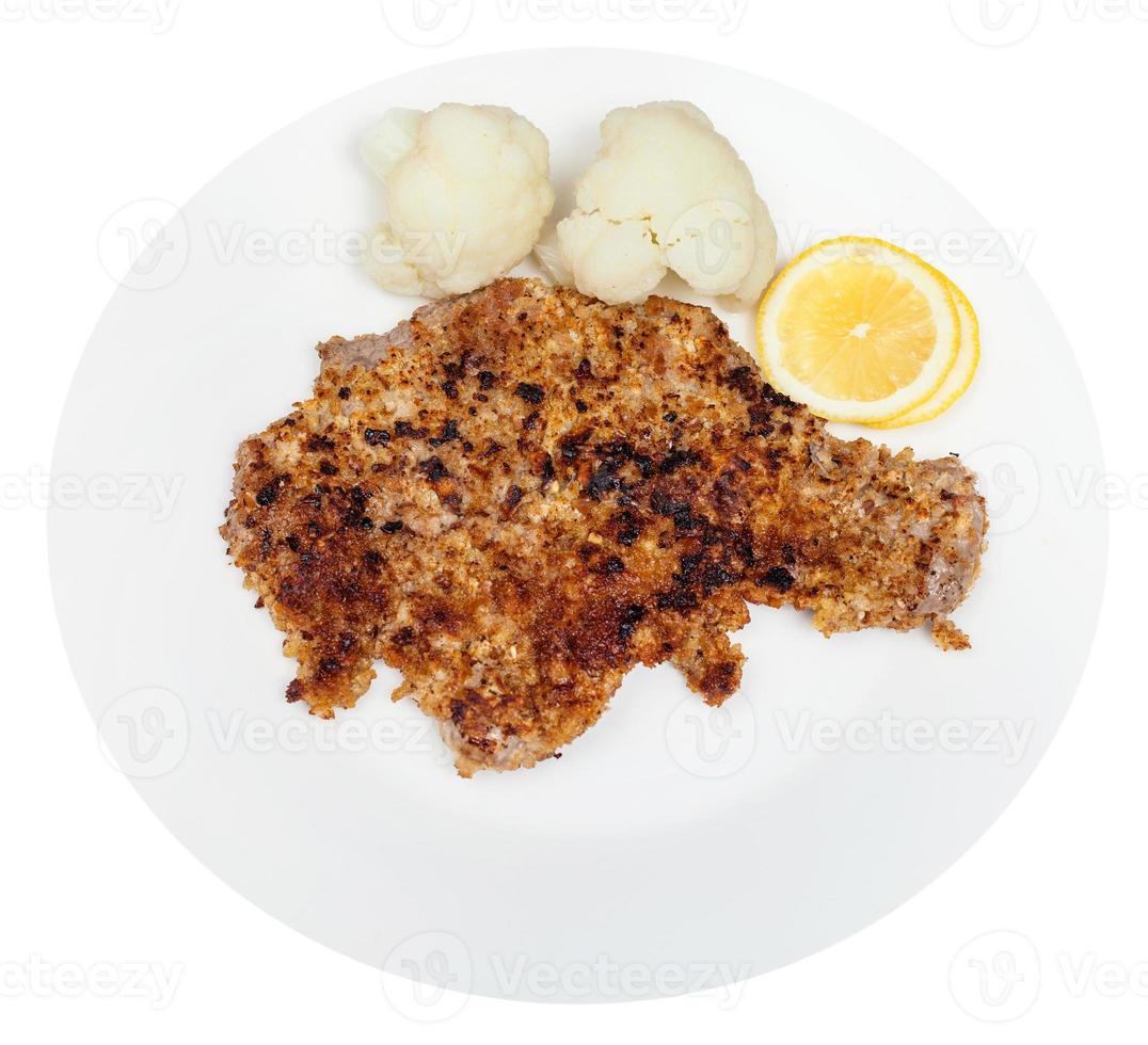 friterad kalvkött schnitzel, kokt blomkål, citron- foto