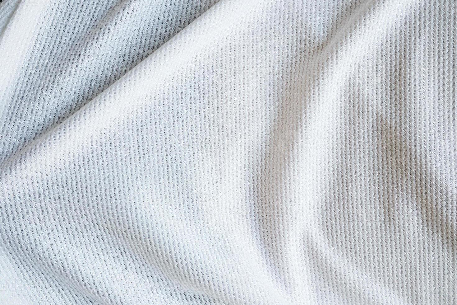 vit fotbollströja kläder tyg textur sport slitage bakgrund foto