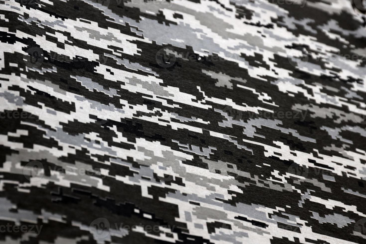 tyg med textur av ukrainska militär pixeled kamouflage. trasa med camo mönster i grå, brun och grön pixel former. officiell enhetlig av ukrainska soldater foto