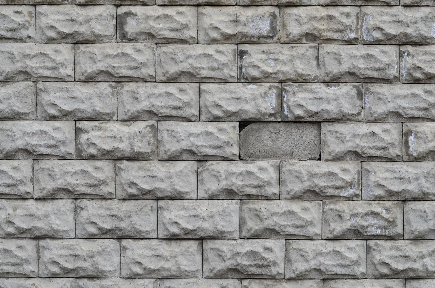 grå betong blockera vägg textur med knäckt yta foto