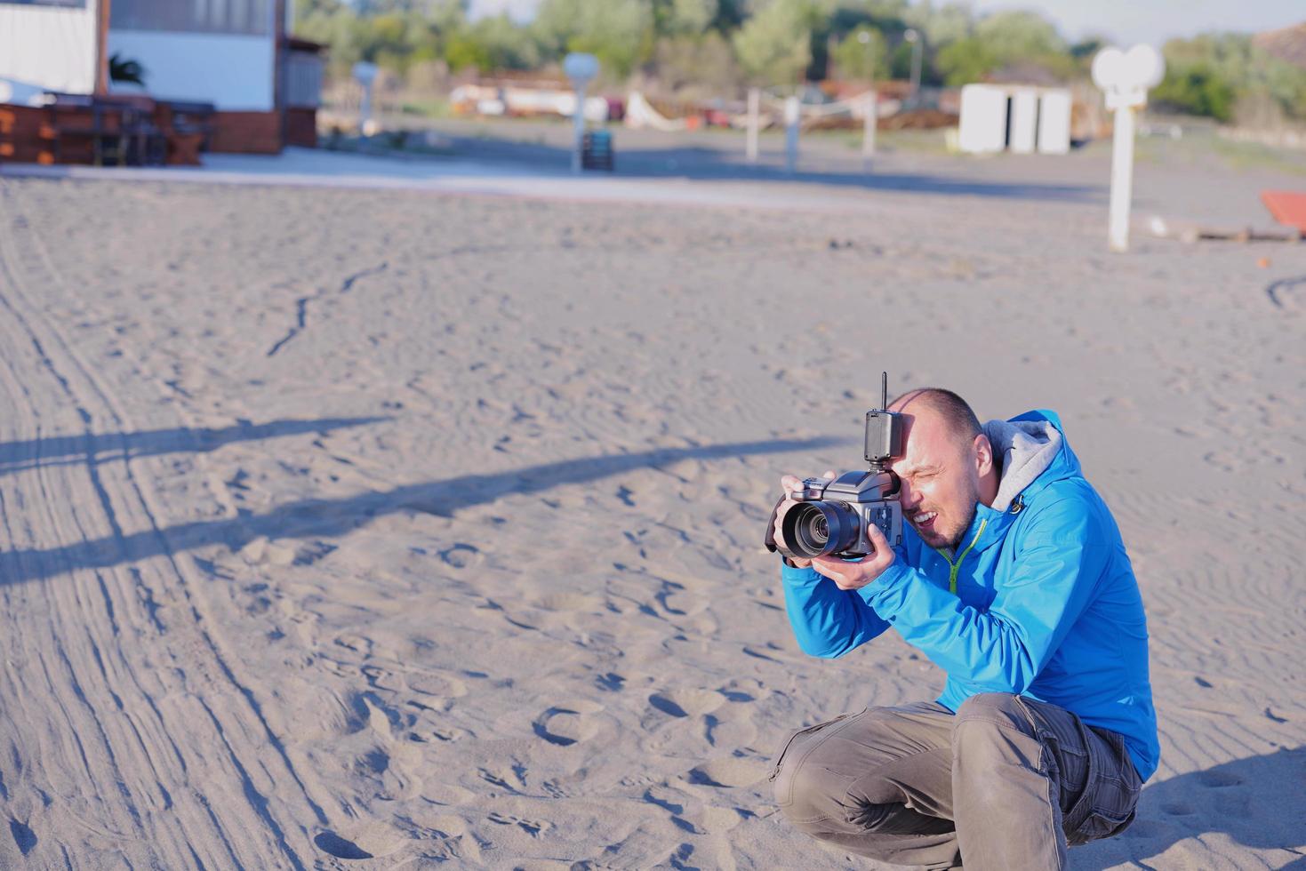 fotograf tar Foto på strand